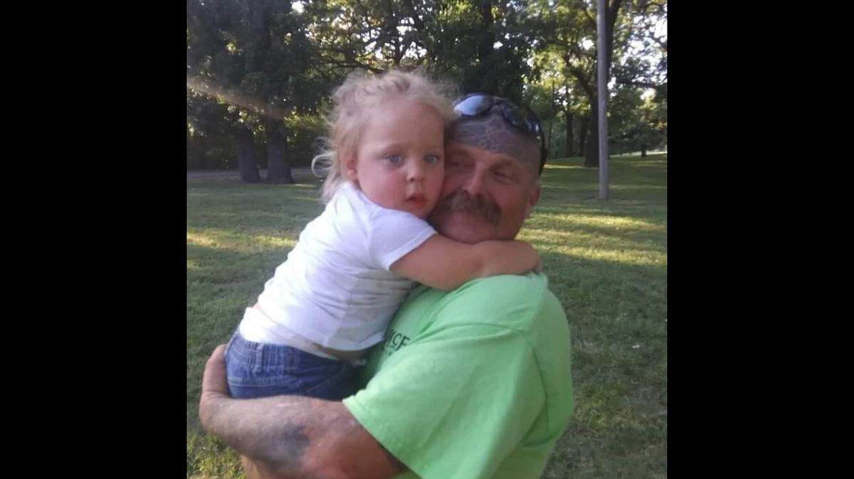 John Anderton, 50, shown here with his daughter, was shot and killed by Kansas City, Kansas, police on Feb. 3, 2023.