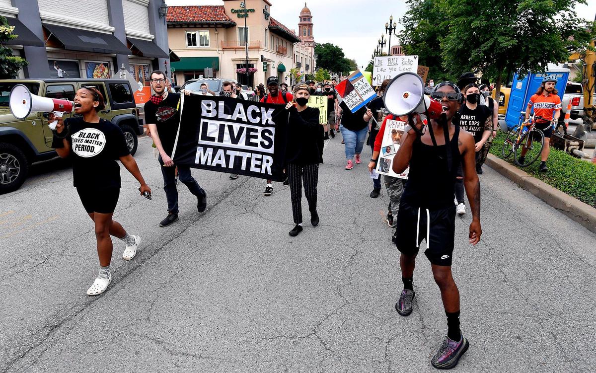 During a George Floyd Memorial March held Tuesday night on the Country Club Plaza, protesters march down 47th Street in memory of Floyd, who was killed one year ago by a police officer in Minneapolis, Minnesota. The event was organized by Black Rainbow of Kansas City.