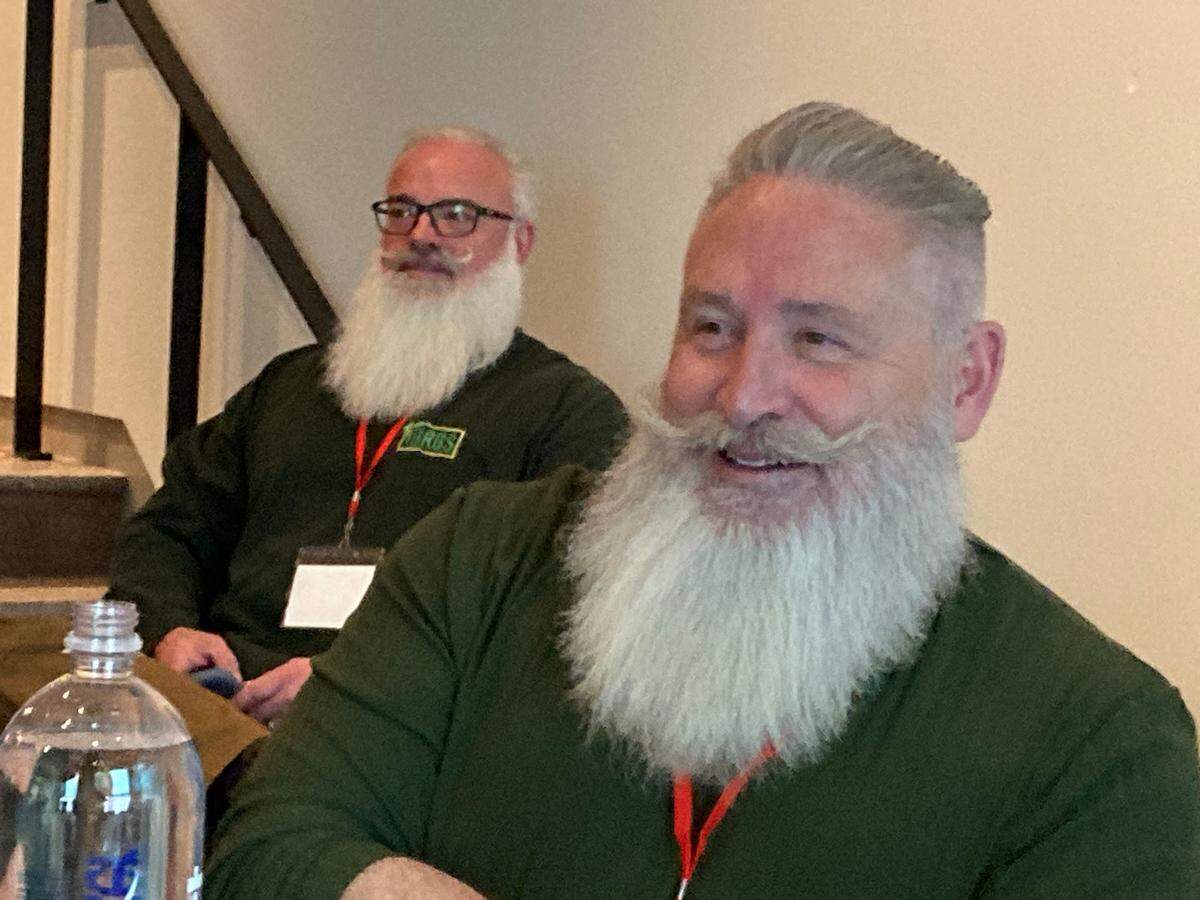 Paul Smith, right, a professional Santa from Atlanta, Georgia, attends the volunteer Santa America conference at The Hotel Savoy in Kansas City. Smith came to learn more about how to be a Santa to children with special needs.
