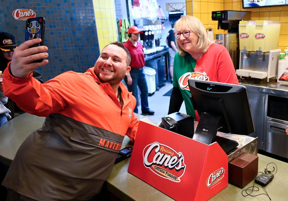 Mike Tannenabaum of Washington, D.C., takes a selfie with Donna Kelce at Raising Cane’s in Overland Park.