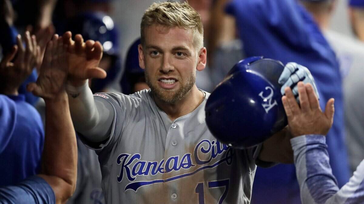 The Royals’ Hunter Dozier is congratulated by teammates after hitting a grand slam in the ninth inning Tuesday night against the Indians in Cleveland. Kansas City scored five runs in the ninth to rally for an 8-6 victory.