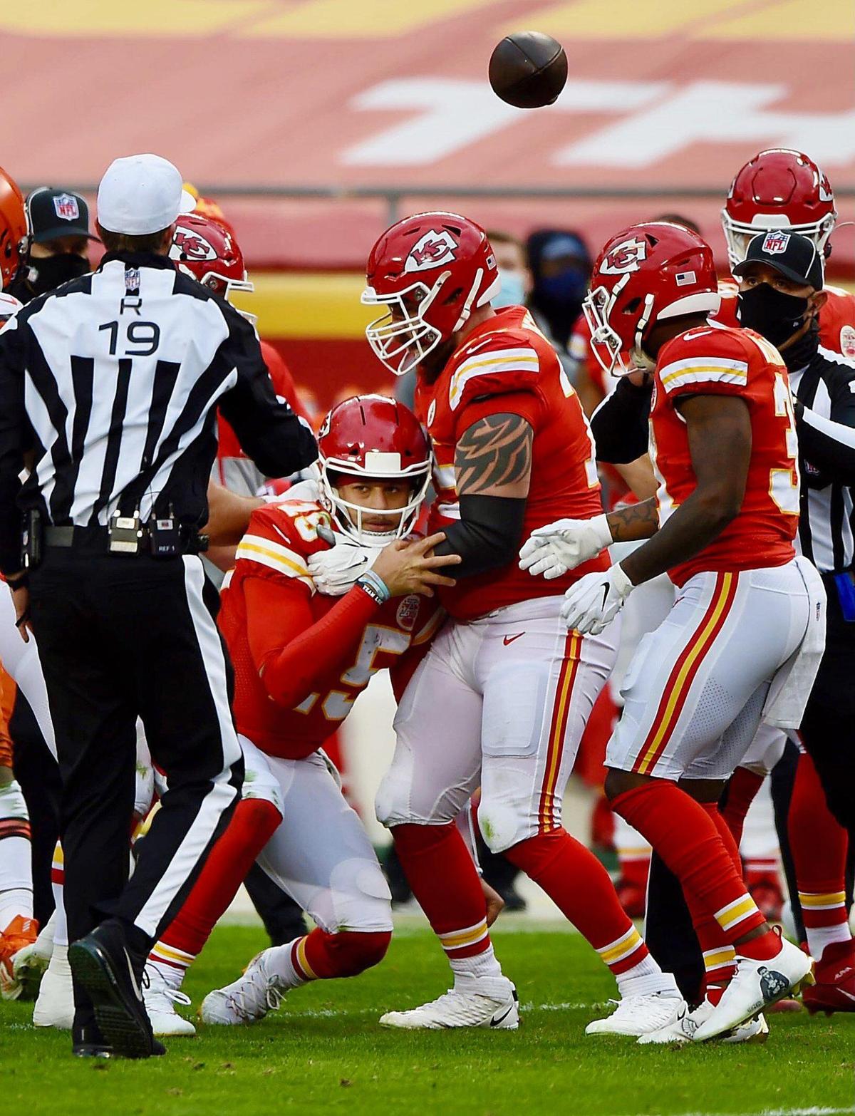 Kansas City Chiefs quarterback Patrick Mahomes is steadied by offensive tackle Mike Remmers after taking a hard hit from the Cleveland Browns in the third quarter Sunday, January 17, 2021, at Arrowhead Stadium in Kansas City, Missouri.