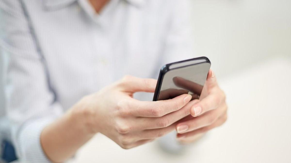 A person holds a smartphone with both hands.
