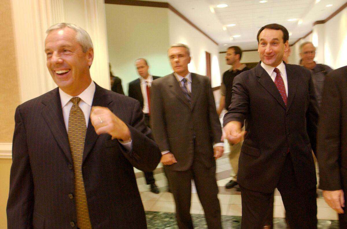 UNC head basketball coach, Roy Williams, left, laughs with Duke’s Mike Krzyzewski on their way to a photo op.