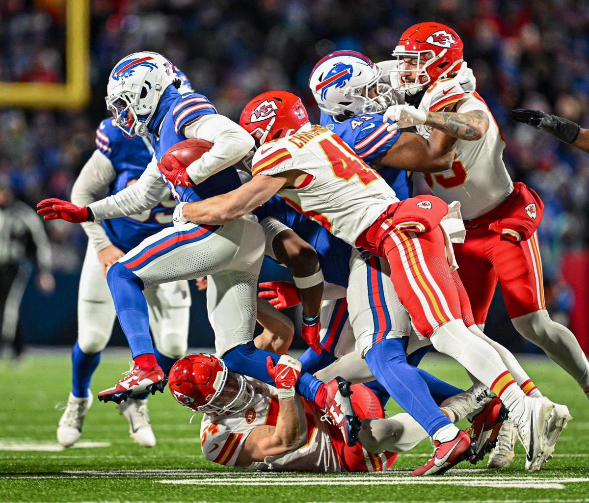 Kansas City Chiefs linebacker Cole Christiansen (48) and Kansas City Chiefs linebacker Leo Chenal (54) stop Buffalo Bills safety Damar Hamlin (3) while he makes a carry on a fake punt in the second half Sunday, Jan. 21, 2024, at Highmark Stadium in Orchard Park, New York.