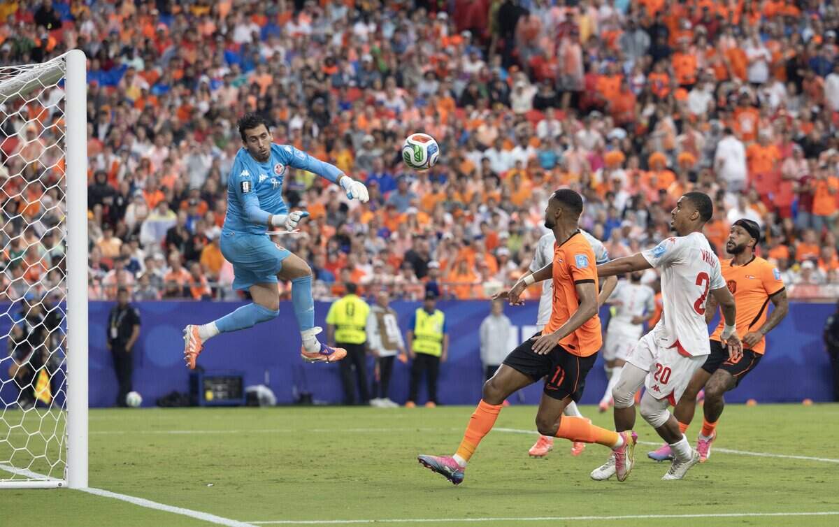 Tunisia goalkeeper Mouhib Chamakh (1) blocks a shot against the Netherlands during a FIFA World Cup group-stage soccer match at Kansas City (Arrowhead) Stadium in Kansas City on Thursday, June 25, 2026.