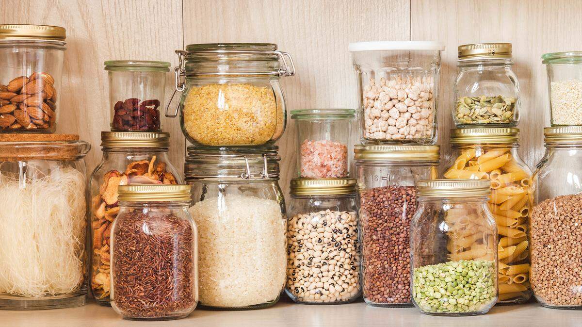 A well-organized pantry stocked with oils, grains, canned goods and spices — the foundation of consistent, healthy home cooking.