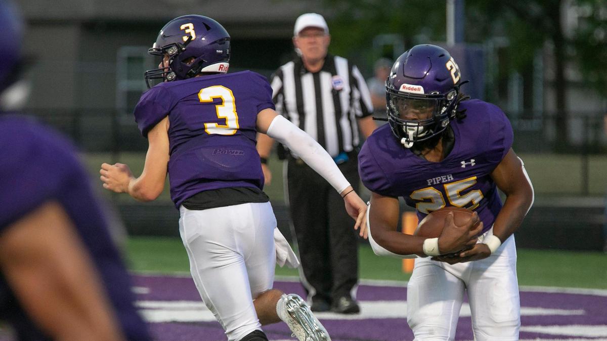 Piper’s Logan Ladish, #3 handed the ball off to Jaylon Pride #25 during the game against Eudora at Piper, Friday, September 10, 2021.