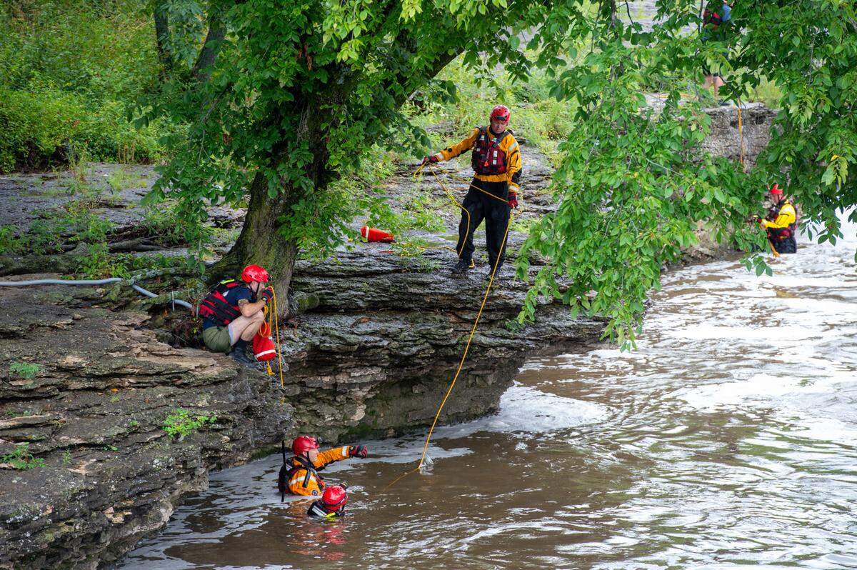 KCFD firefighter continue searching for Trevion Mcafee at Indian Creek Monday morning. Mcafee, a sophomore at Metropolitan Community College, was possibly swept away by currents at Indian Creek Sunday night.