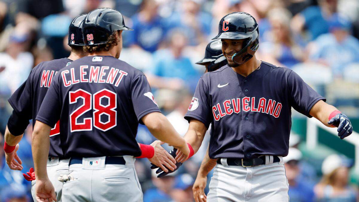 Cleveland Guardians’ Oscar Mercado, right, is congratulated by Ernie Clement (28) and other teammates after hitting a grand slam home run during the first inning of a baseball game against the Kansas City Royals in Kansas City, Mo., Sunday, April 10, 2022. (AP Photo/Colin E. Braley)