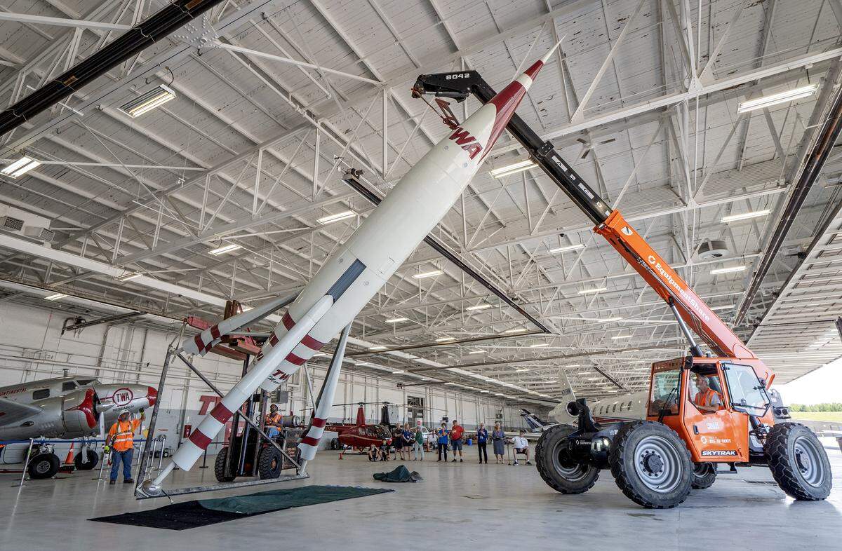 The TWA Moonliner II is hoisted upright after it was moved into the TWA Museum on Saturday.