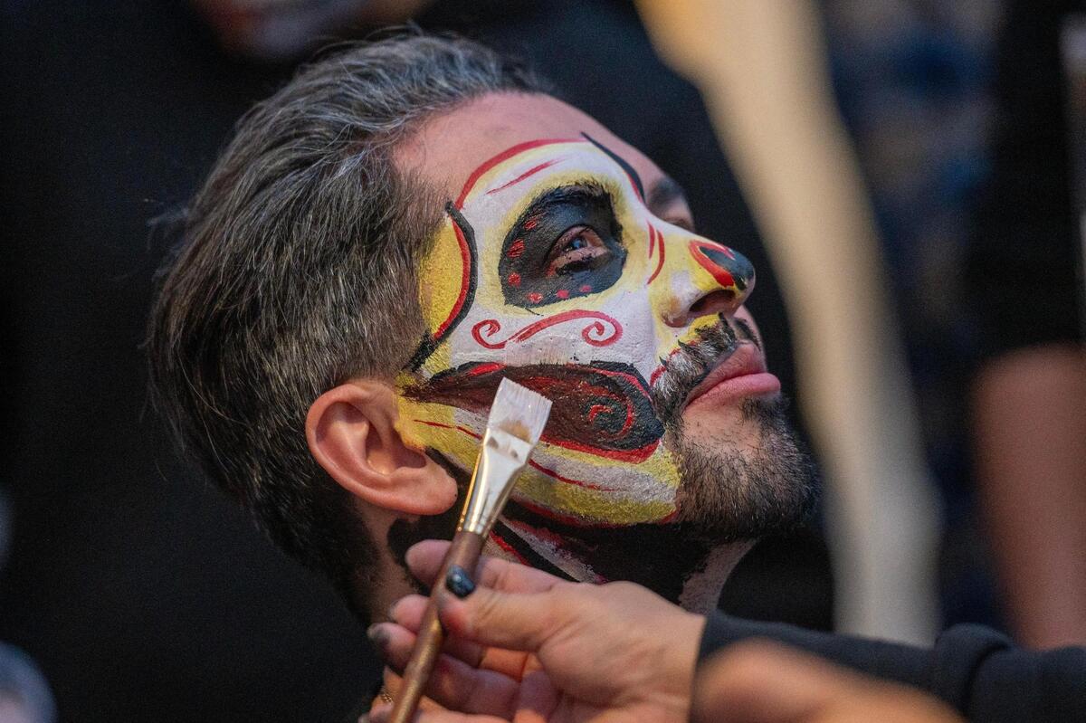 Rigo Jurado has his face painted during the Dia de los Muertos festival at the Mattie Rhodes Center.