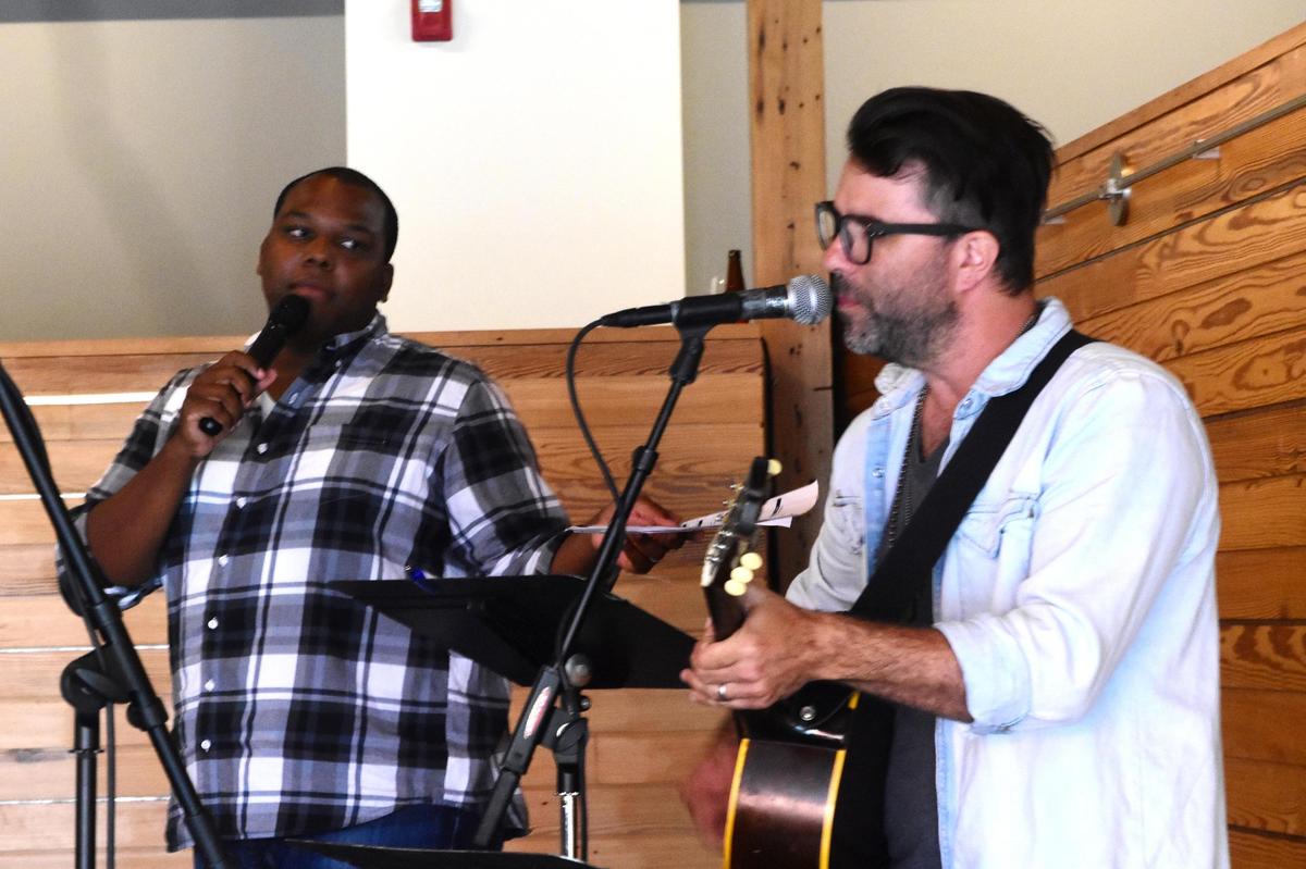 Vocalist Jazz Rucker (left) and guitarist Jared Scholz practiced with more than 50 singers to fine-tune “Ain’t No Mountain High Enough.”