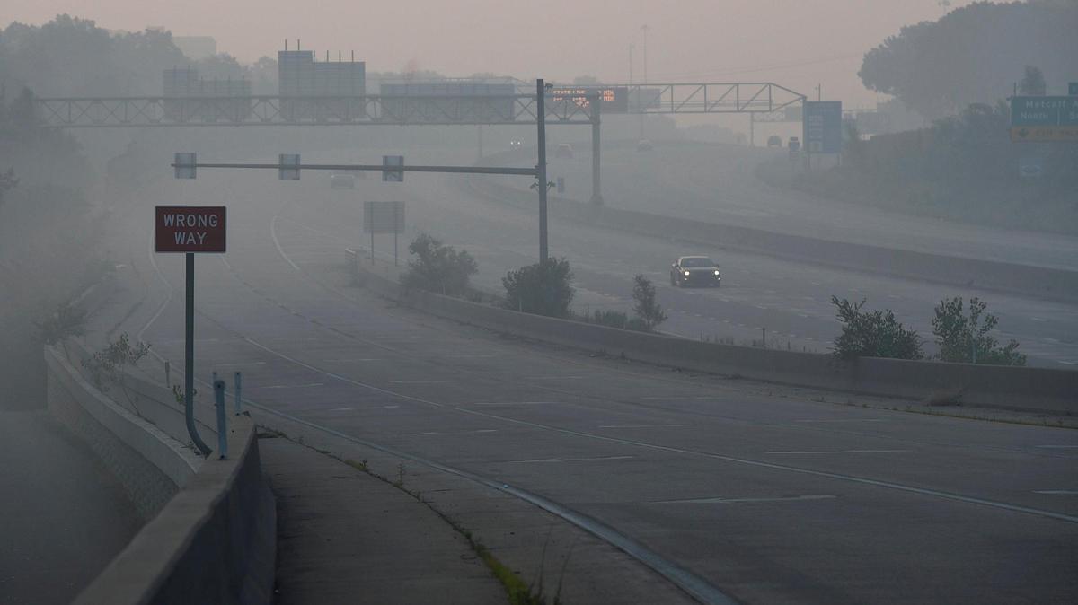 Thick smoke from Independence Day fireworks fired hours earlier hung in the air over I-435 in Overland Park on July 5, 2020. The National Weather Service issued a special weather advisory warning of unhealthy conditions due to an air inversion that kept the smoke close to the ground.