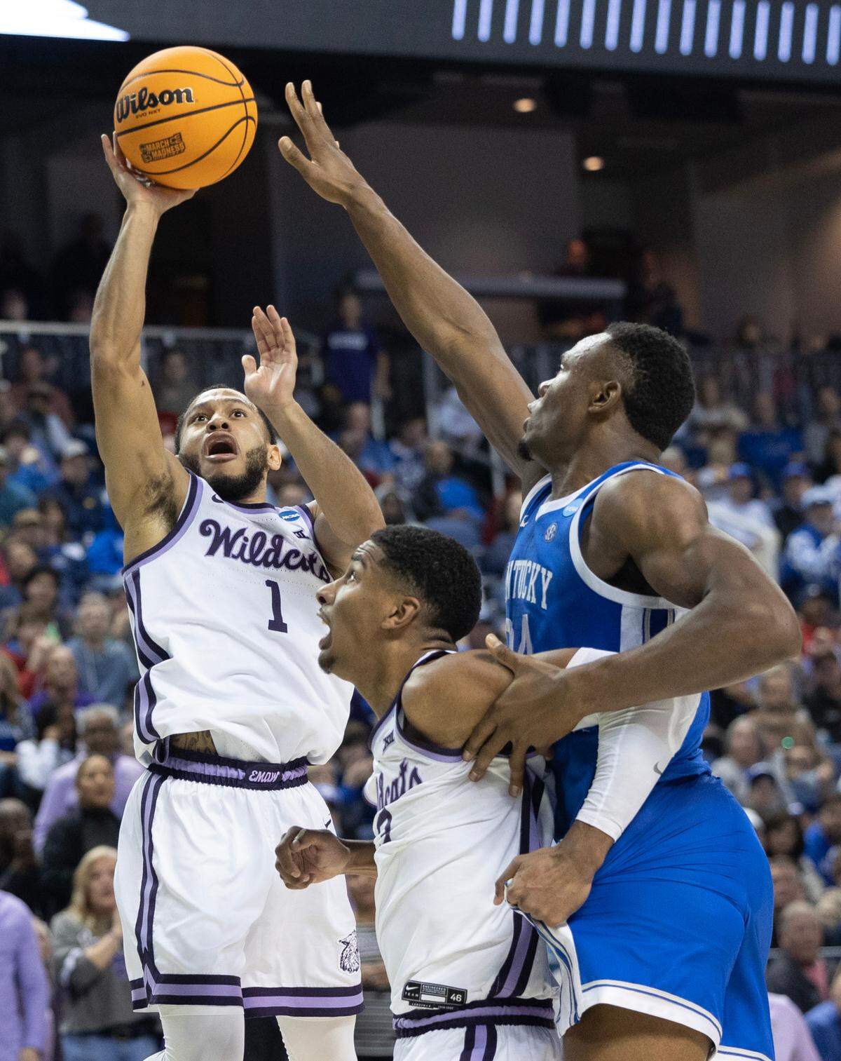 Kansas State’s Markquis Nowell gets a basket against Kentucky defender Oscar Tshiebwe during the second half of their second round NCAA Tournament game in Greensboro, NC on Sunday.