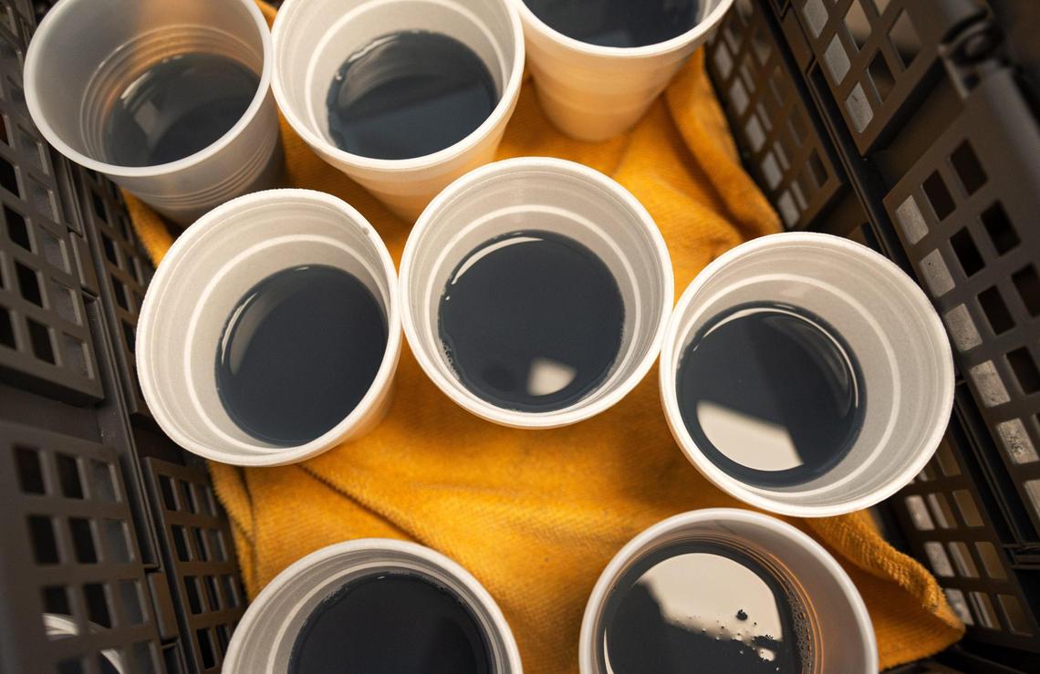 Cups of laundry detergent are offered free on Community Laundry Day at Leah’s Laundromat on the Q.