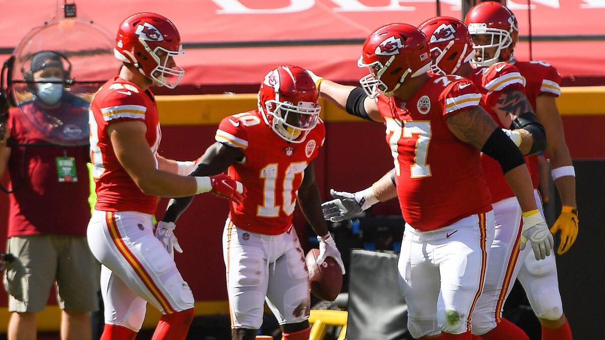 Teammates congratulate Kansas City Chiefs wide receiver Tyreek Hill, 10, after he ran in for a touchdown early in the second quarter against the Las Vegas Raiders Sunday, October 11, 2020, at Arrowhead Stadium in Kansas City, Missouri.