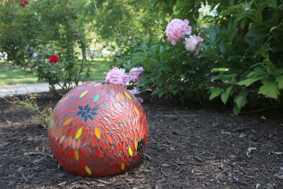 Artist Stefanie Vaughn’s garden sphere is called Firefly Petals. All the spheres will be on display in and around Antioch Park’s rose garden until November.