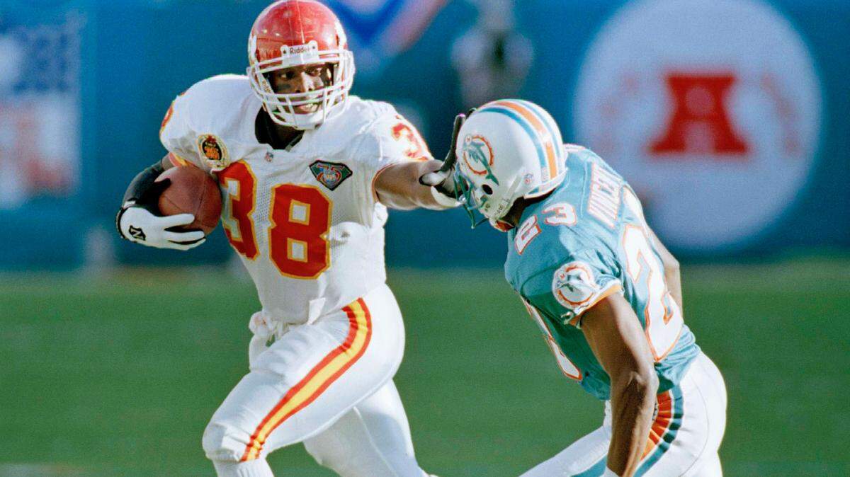 Kansas City Chiefs running back Kimble Anders (38) stiff arms Miami Dolphins defensive back Troy Vincent (23) in the first quarter of the AFC playoffs in Miami Saturday, Dec. 31, 1994. (AP Photo/Lynne Sladky)