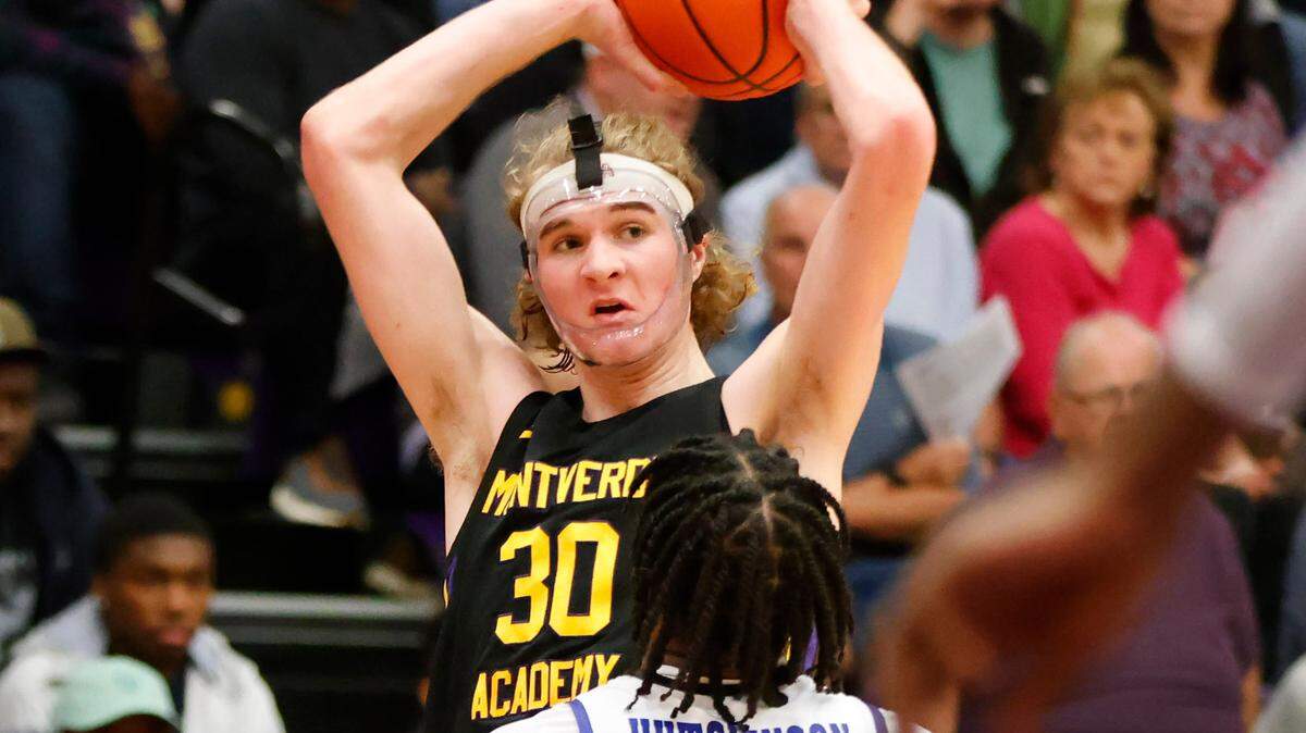 Montverde Academy forward Liam McNeeley (30) looks to pass over IMG Academy’s Jacoi Hutchinson during the second half of the Sunshine Classic basketball tournament at Mills Championship Court on Dec. 1, 2022.