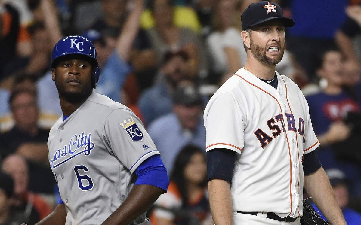 Houston Astros' pitcher Scott Feldman, right, reacts after his throwing error allowed Kansas City Royals' Lorenzo Cain (6) to score in the sixth inning of a baseball game, Wednesday, April 13, 2016, in Houston. 