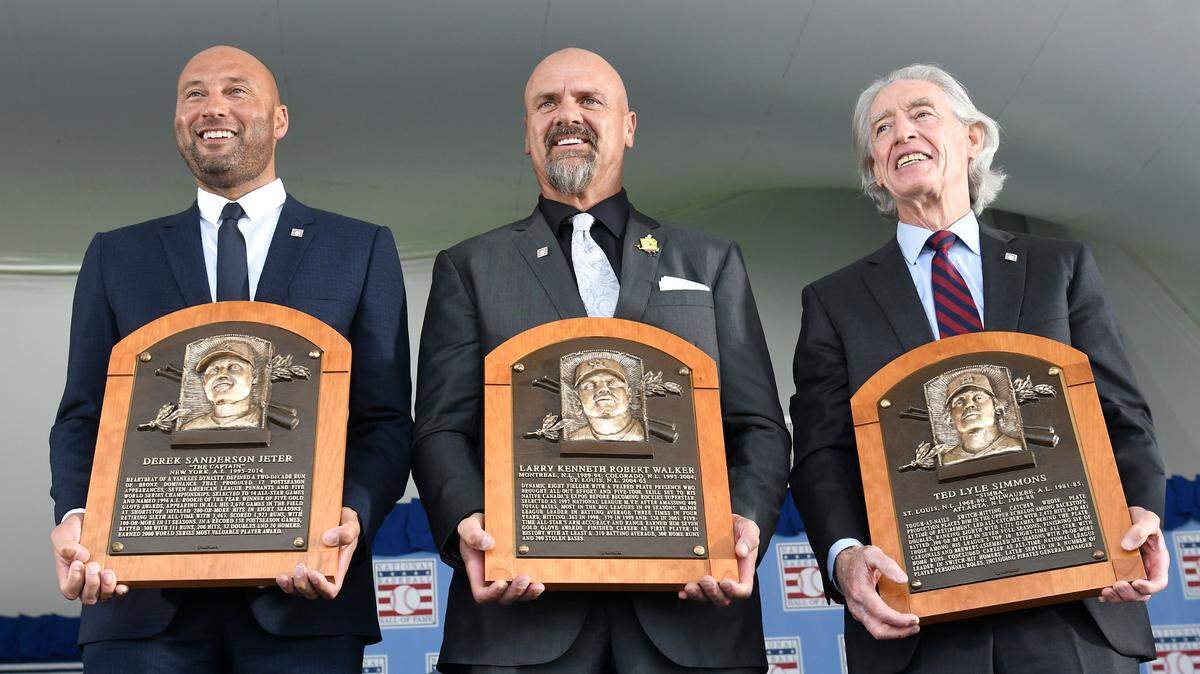 Hall of Fame inductees, from left, Derek Jeter, Larry Walker and Ted Simmons hold their plaques for photos after the induction ceremony at Clark Sports Center on Wednesday, Sept. 8, 2021, at the National Baseball Hall of Fame in Cooperstown, N.Y. (AP Photo/Hans Pennink)