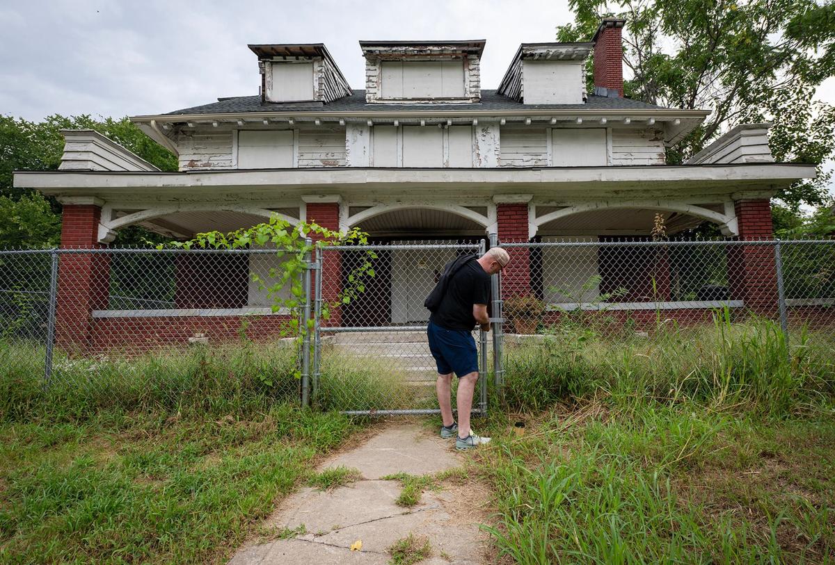 Architect Robert Riccardi of Multistudio unlocks the gate surrounding the former home of Negro Leagues baseball legend Satchel Paige. Riccardi is a leader with Pitch Perfect KC, which aims to restore the 3,700-square-foot home and establish it as a landmark.