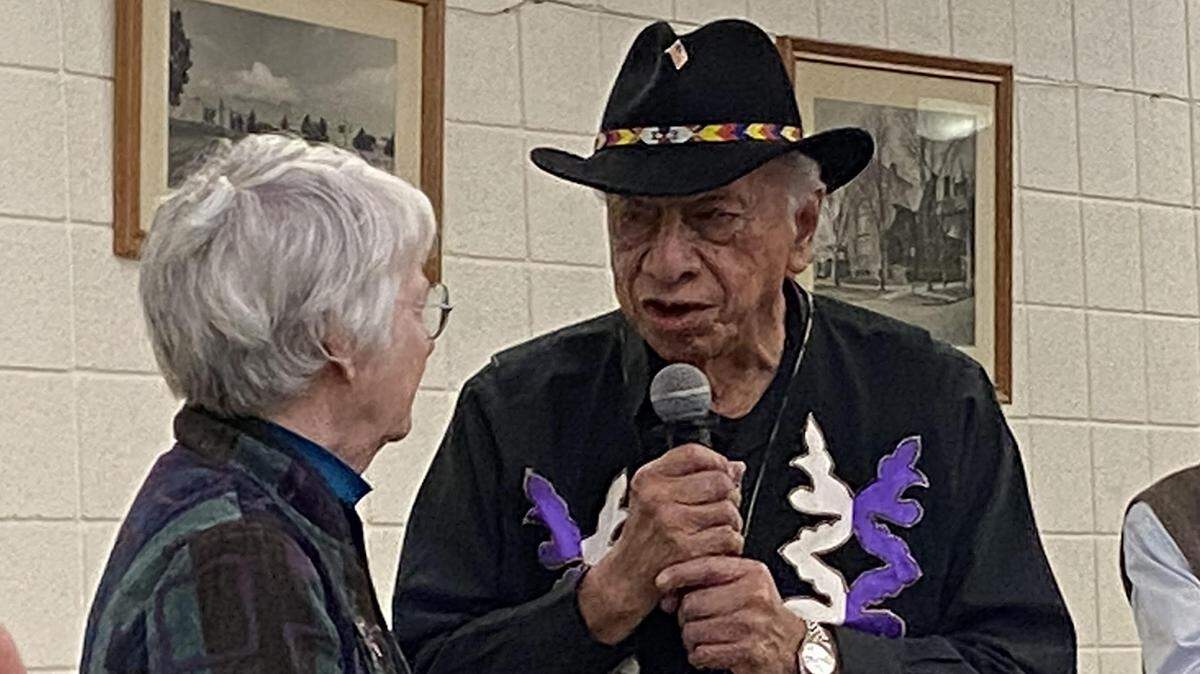 Steve Cadue, Kickapoo elder, asks state Rep. Marci Francisco, a Lawrence Democrat, for a statement of support from Gov. Laura Kelly at a rally Friday night.
