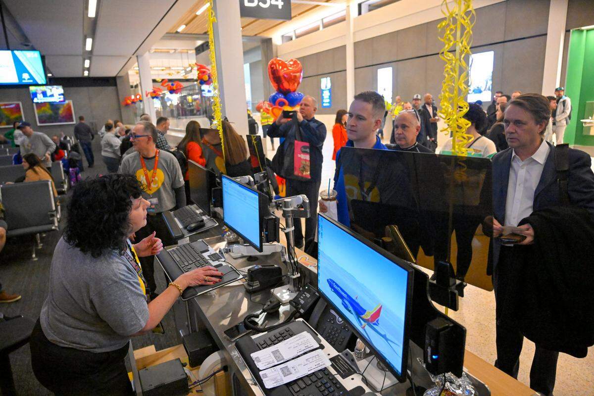 LIsa DeLano, an agent for Southwest Airlines checked travelers in for the 5 a.m. flight to Chicago, the first flight departing from the new $1.5 billion single terminal at Kansas City International Airport on Tuesday, Feb. 28, 2023.