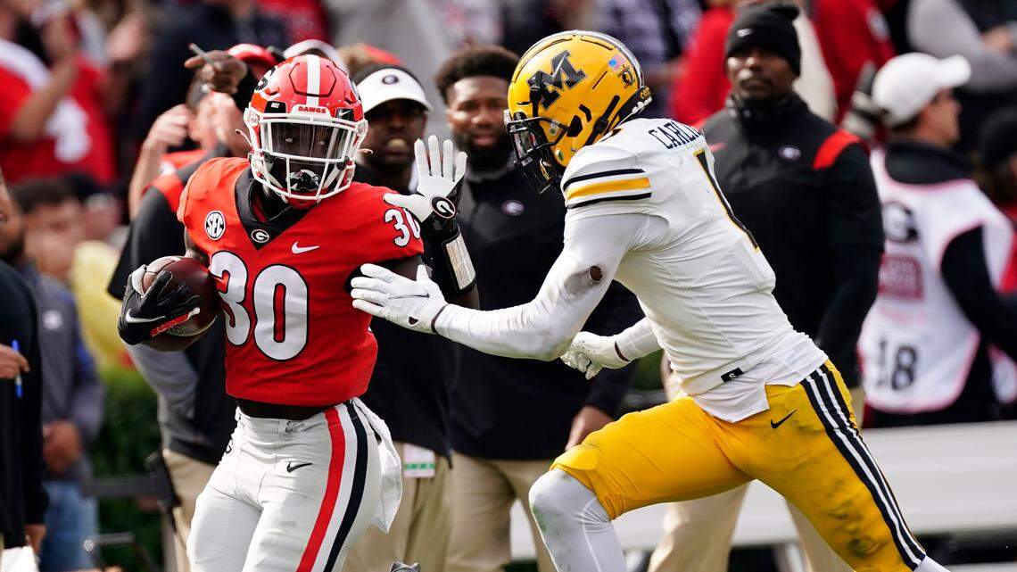 Georgia running back Daijun Edwards (30) is run down by Missouri defensive back Jaylon Carlies (1) after a catch in the second half of an NCAA college football game Saturday, Nov. 6, 2021, in Athens, Ga. (AP Photo/John Bazemore)