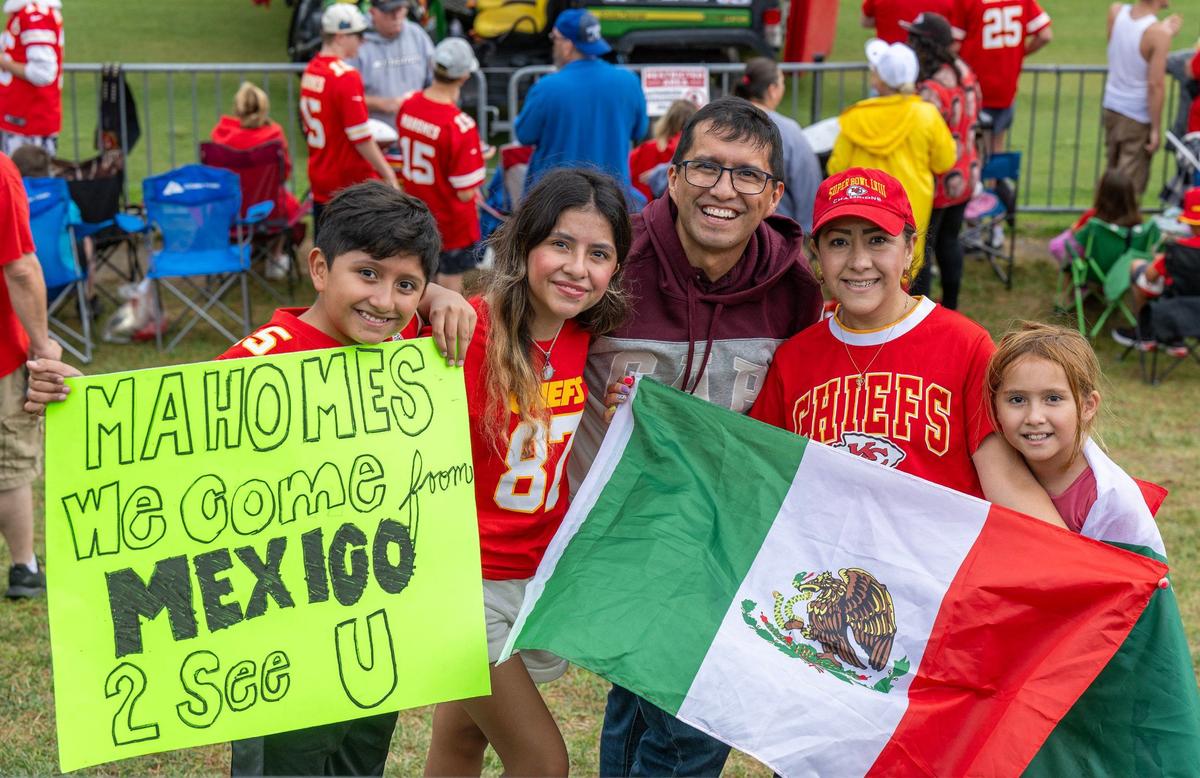 Kansas City Chiefs fans Genaro Millan and his wife Paola, center, with their children Patricio, 13, Paola, 16, and Helena, 9, of Mexico City, proudly display their Mexican heritage and support for the Chiefs with signs and flags at training camp in St. Joseph.