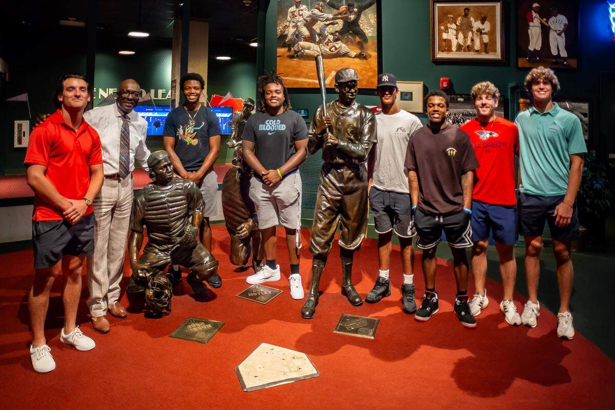 Negro Leagues Baseball Museum president Bob Kendrick poses with Ban Johnson Collegiate League players after a tour of the Field of Legends on Wednesday, July 19, 2023.