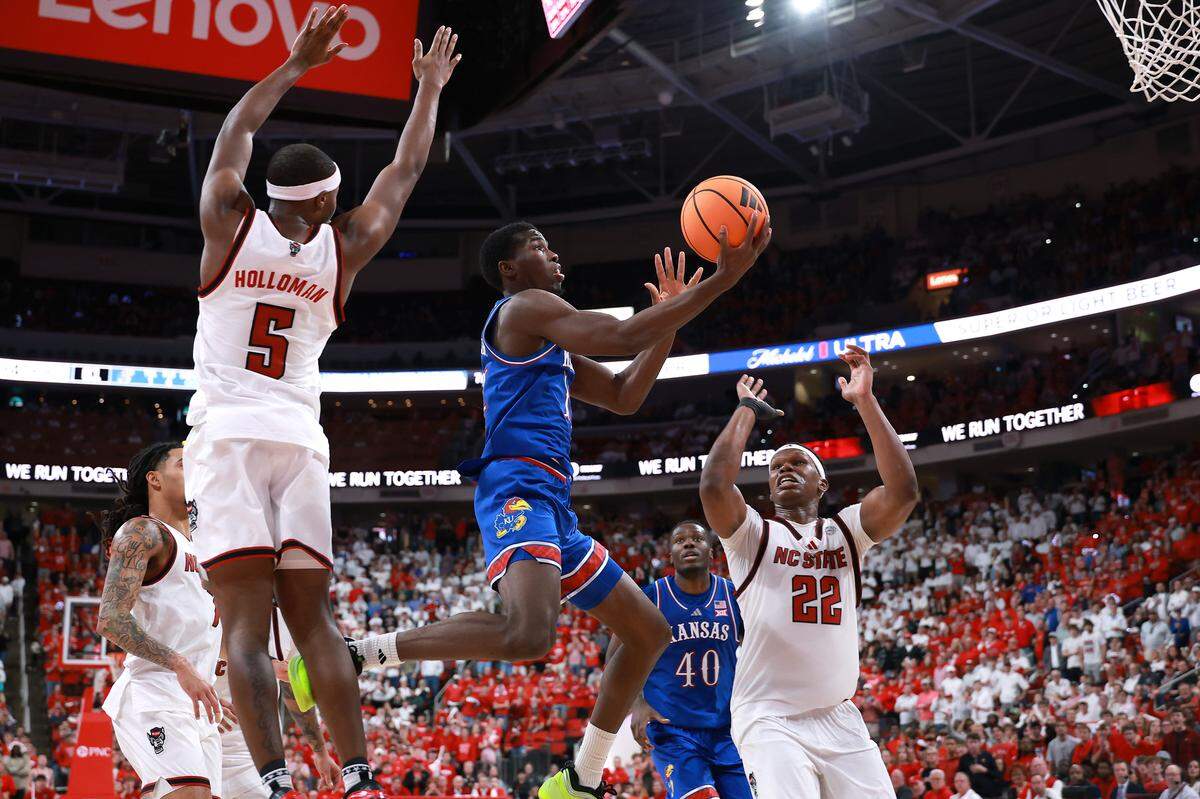 Melvin Council Jr. #14 of the Kansas Jayhawks drives to the basket against the NC State Wolfpack during the second half of the game at Lenovo Center on December 13, 2025 in Raleigh, North Carolina.