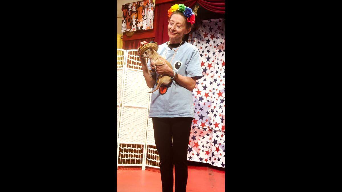 Martin City Melodrama & Vaudeville Company owner Jeanne Beechwood onstage with rescue dog Lil Bit in “The Great American Melodogma.”