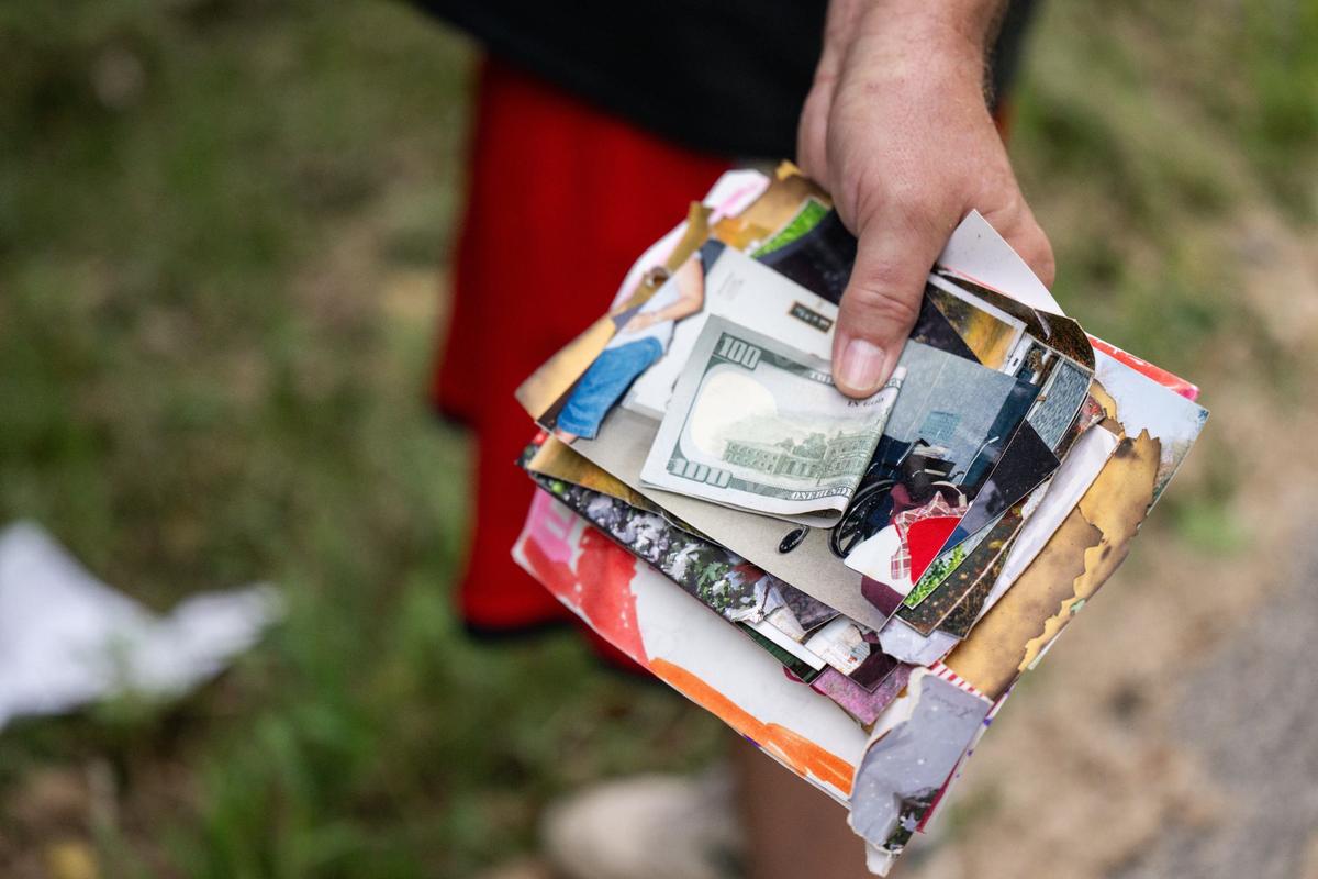 Ed Whitesel of Kearney helps to collect keepsakes and money from a home explosion that happened in the early morning hours of Friday in Excelsior Springs. Whitesel was in the area checking on a friend.