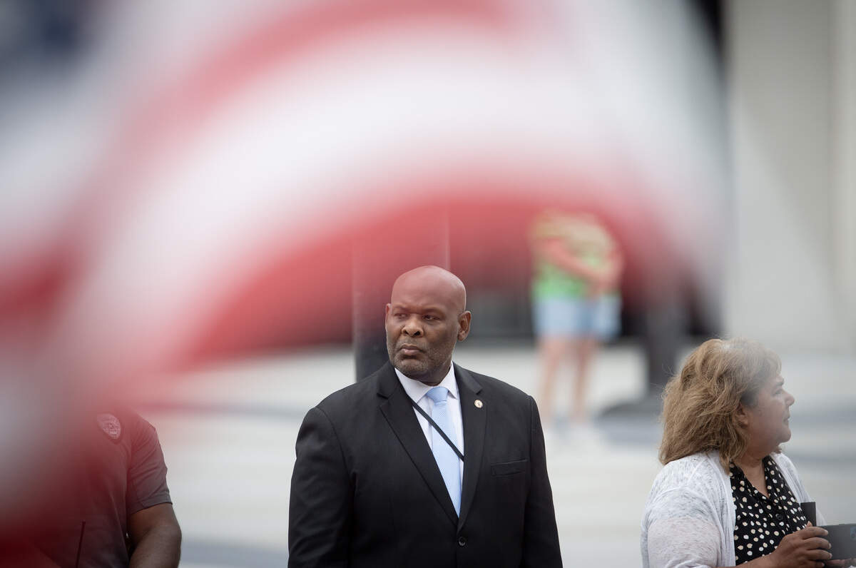 Wyandotte County Unified Government mayor/CEO Tyrone Garner watches the funeral procession of Wyandotte County Sheriff's deputy Elijah Ming pass through downtown Kansas City, Kansas, on Monday, August 11, 2025.