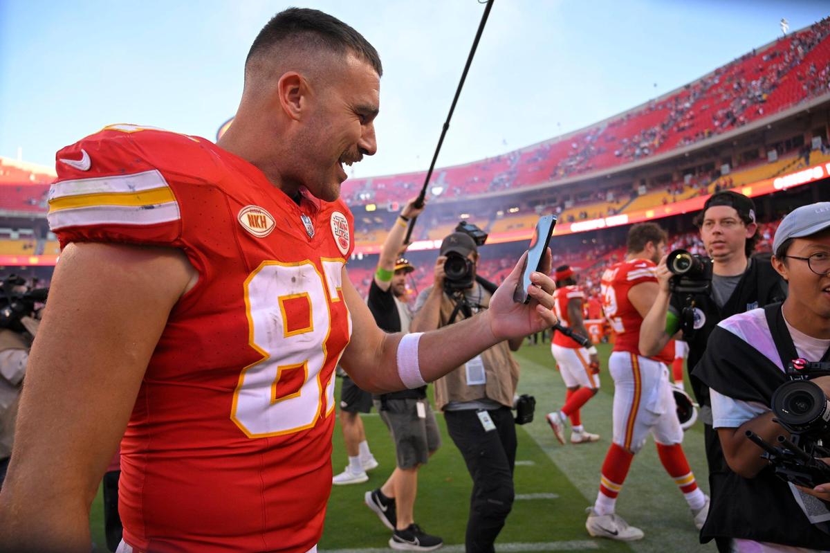 Kansas City Chiefs tight end Travis Kelce (87) talks into his phone as he leaves the field after the Chiefs defeated Chicago, 41-10, on Sunday, Sept. 24, 2023, at GEHA Field at Arrowhead Stadium in Kansas City. Pop superstar Taylor Swift was at the game at the invitation of Kelce.