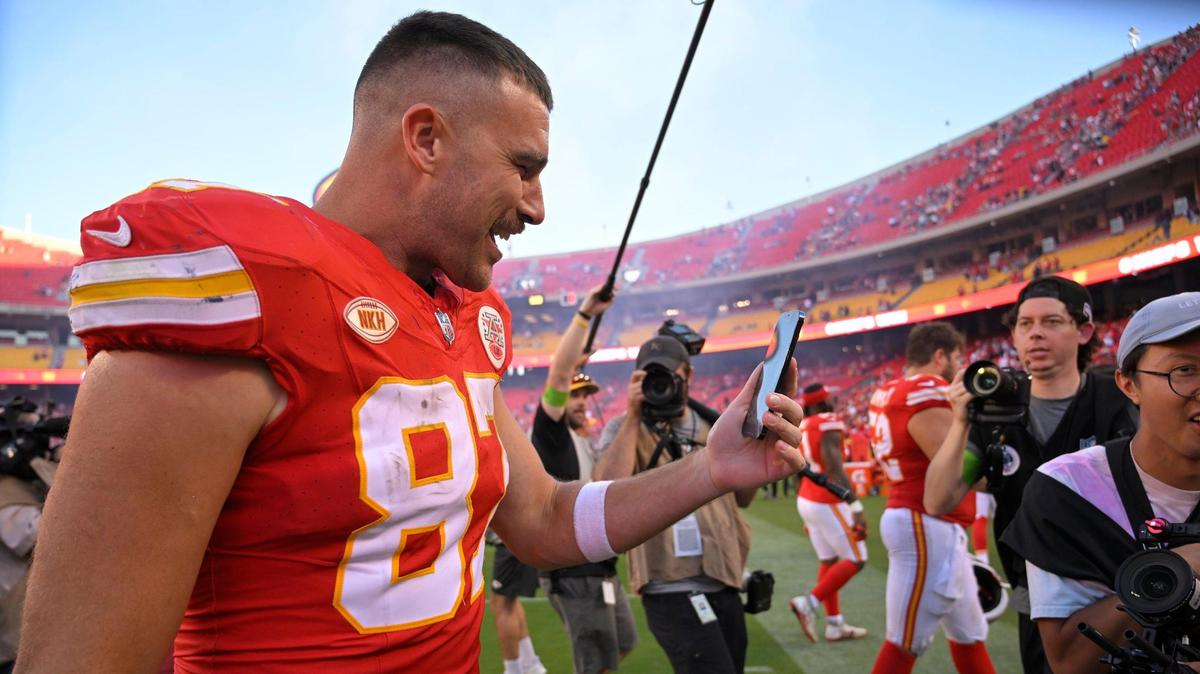 Kansas City Chiefs tight end Travis Kelce (87) talks into his phone as he leaves the field after the Chiefs defeated Chicago, 41-10, on Sunday, Sept. 24, 2023, at GEHA Field at Arrowhead Stadium in Kansas City. Pop superstar Taylor Swift was at the game at the invitation of Kelce.