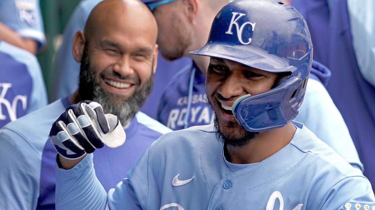 Kansas City Royals’ Edward Olivares celebrates in the dugout after hitting a solo home run during the fourth inning of a baseball game against the Minnesota Twins Thursday, Sept. 22, 2022, in Kansas City, Mo. (AP Photo/Charlie Riedel)