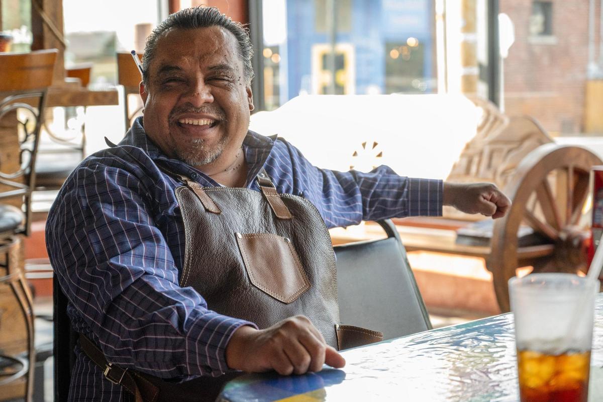 Augustine Juarez, owner of Los Alamos Cocina, chats with customers.