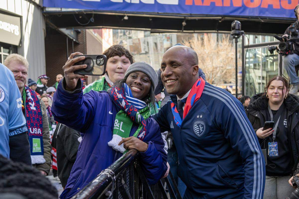 Kansas City Mayor Quinton Lucas takes photos with guests during a FIFA World Cup draw watch party at the Power & Light District on Friday, Dec. 5, 2025.