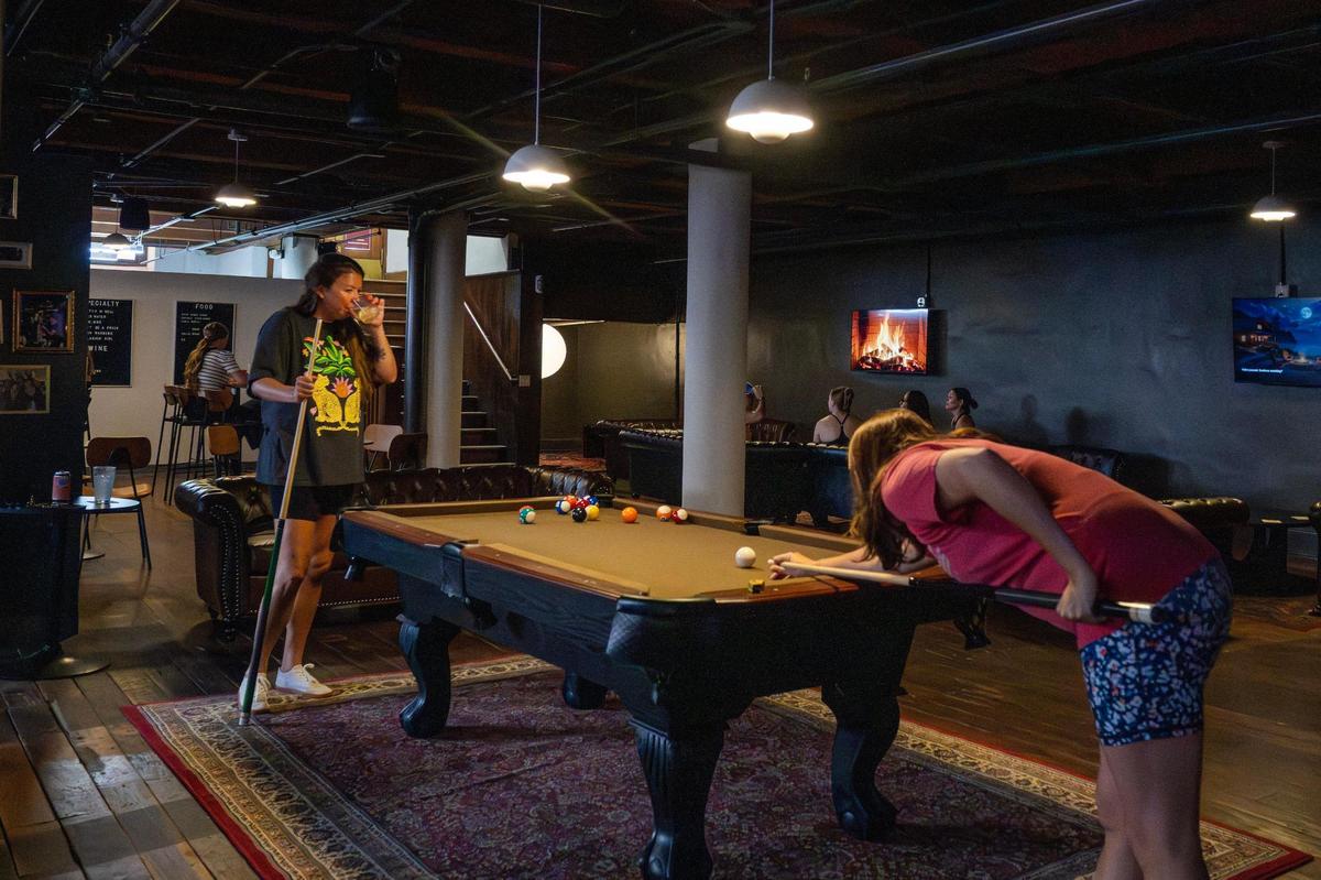 Guests play pool at Something Good near the bar area on Wednesday, July 16, Kansas City.
