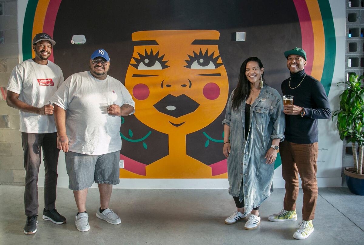Owners of Vine Street Brewing Co., Kansas City’s first black-owned brewery Elliott Ivory (left) Woodie Bonds Jr., Annie McGinnis and Kemet Coleman in front of Maris the beer goddess.