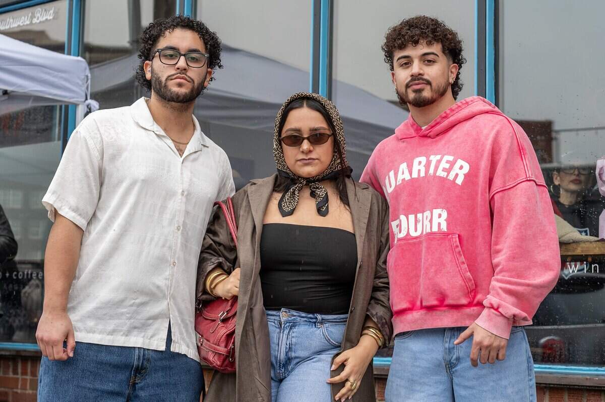 Nelson Rivera, left, and Hannia Zavala, contestants in the Bad Bunny look-alike contest, and Alfredo Mondragon, who arrived late and could not compete, stand for a portrait outside Café Corazón on Saturday, Feb. 14, 2026, in Kansas City.