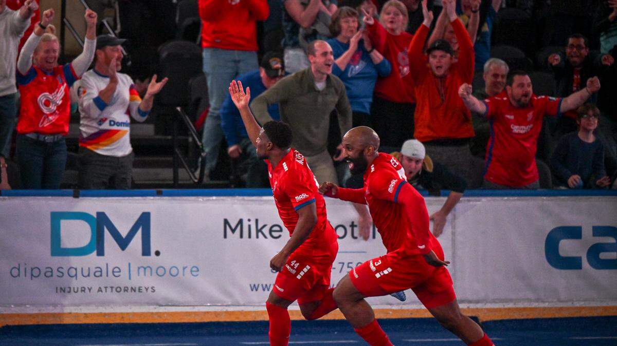 Junior Kazeem (left) and Ray Lee celebrate the go-ahead goal in the final minute of the Comets’ 6-5 win against the St. Louis Ambush.