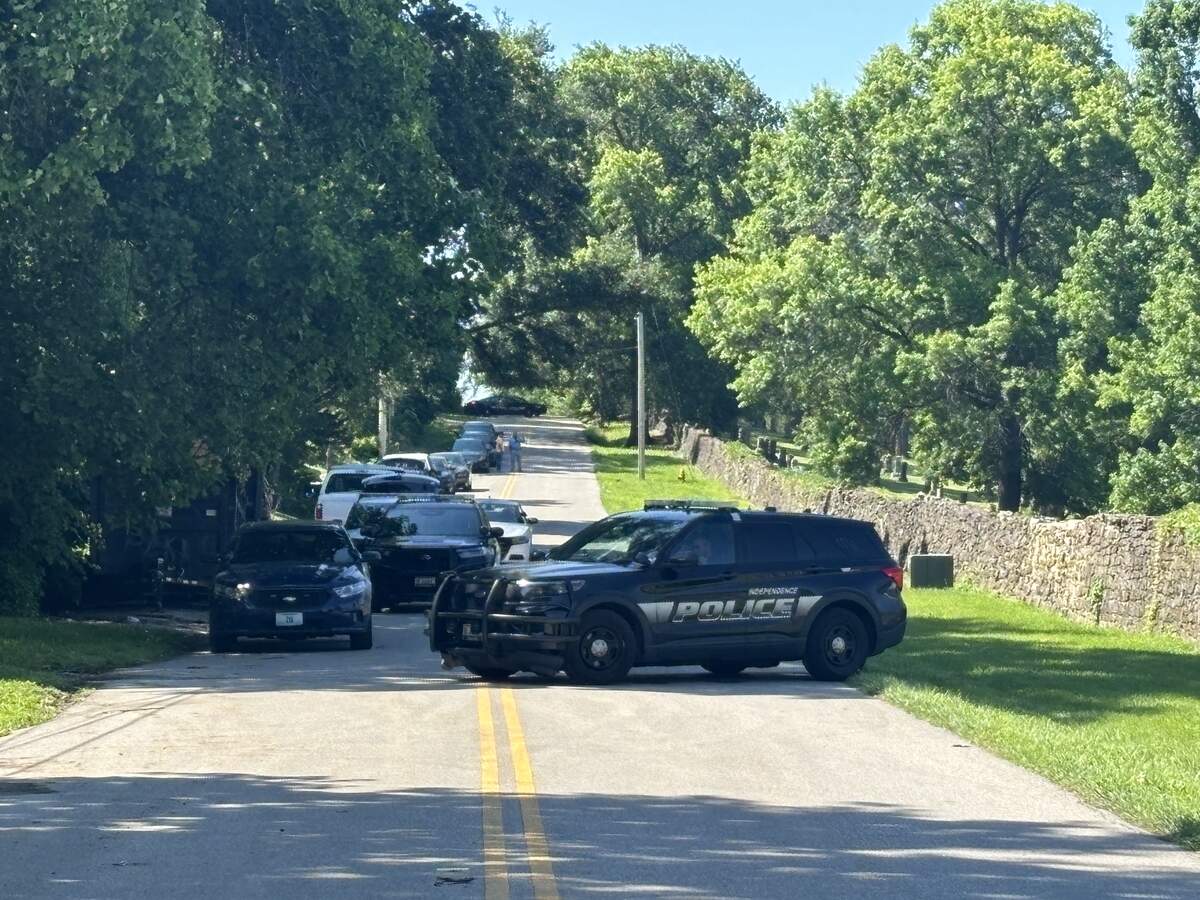 An Independence police vehicle is seen in the 700 block of South Brookside Avenue in Independence. A large police presence was still active Wenesday after a standoff involving a Kansas City shooting suspect.