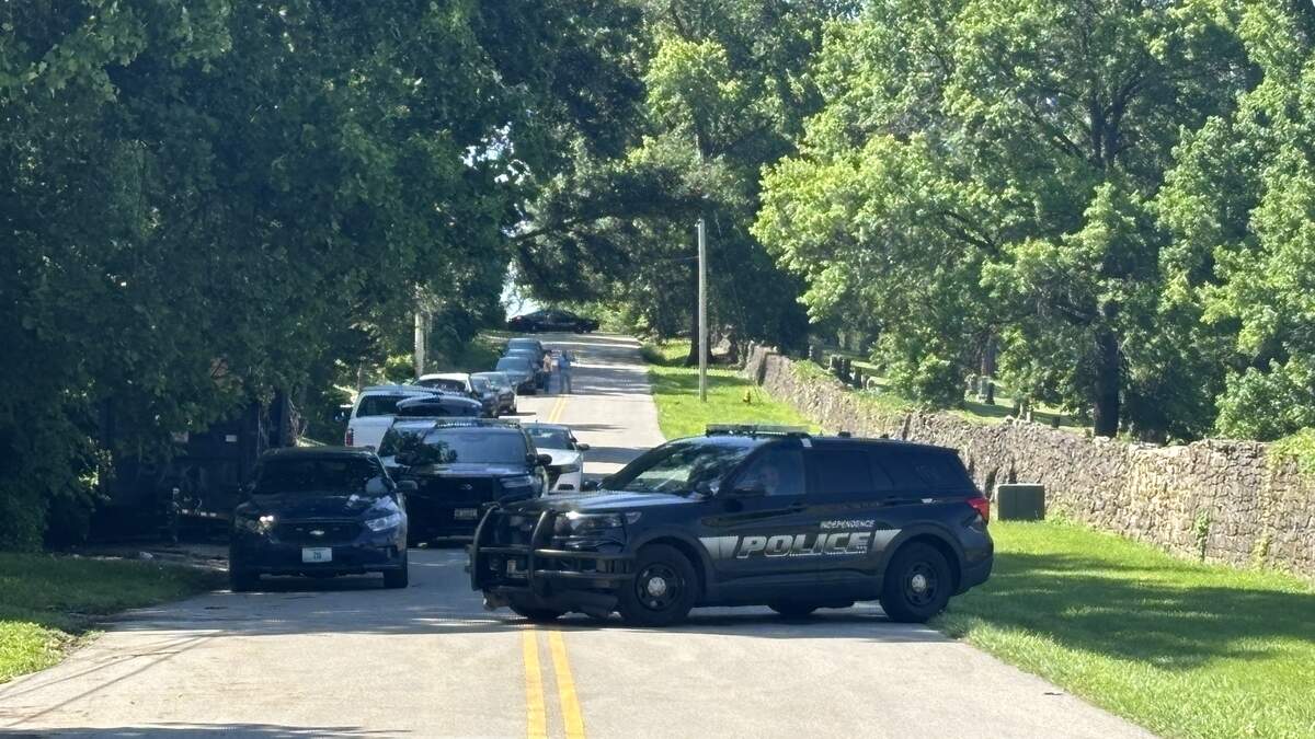 An Independence police vehicle is seen in the 700 block of South Brookside Avenue in Independence. A large police presence was still active Wednesday after a standoff involving a Kansas City shooting suspect.