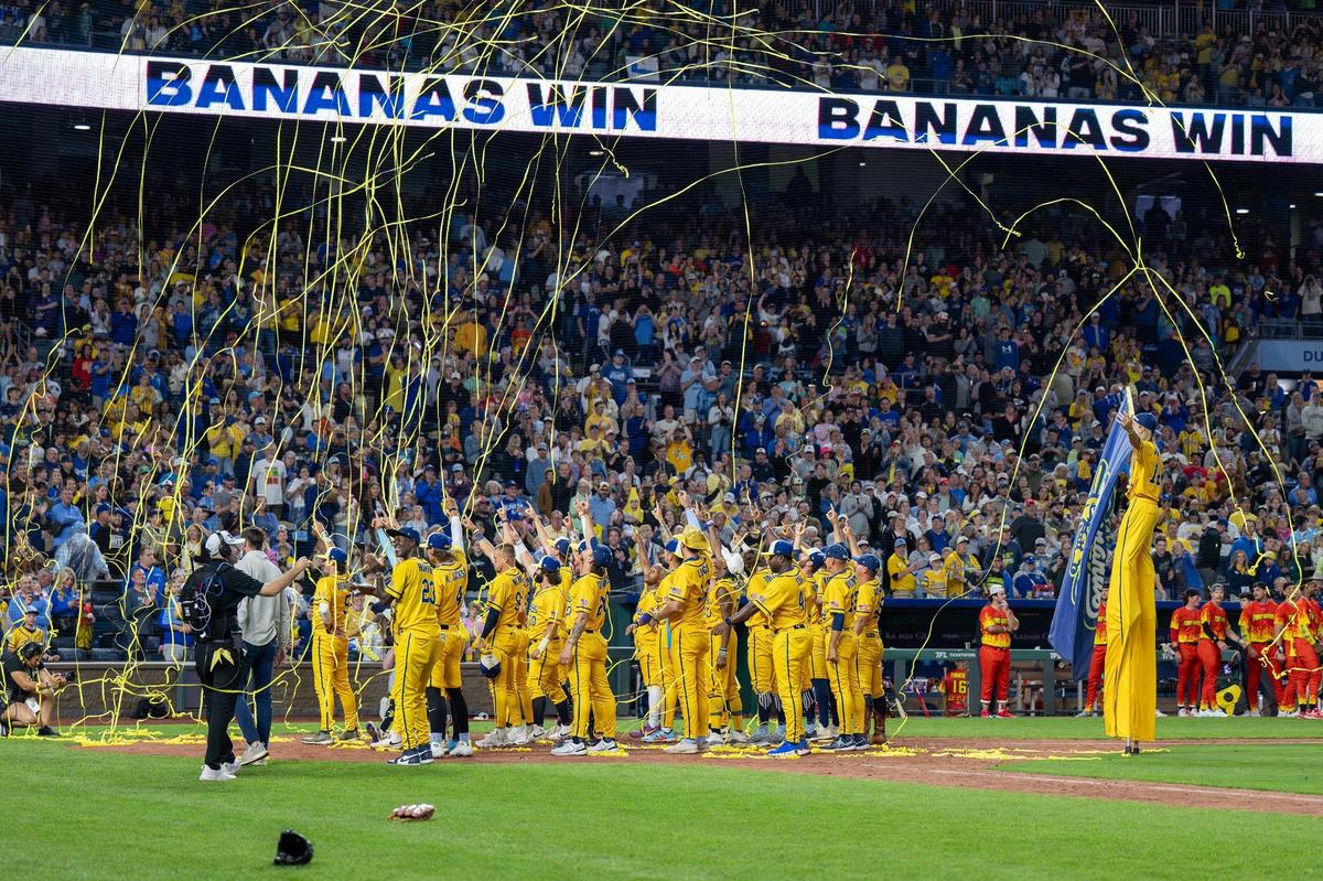 Savannah Bananas players celebrate after defeating the Firefighters during a Banana Ball game at Kauffman Stadium on Friday, May 23, 2025, in Kansas City.