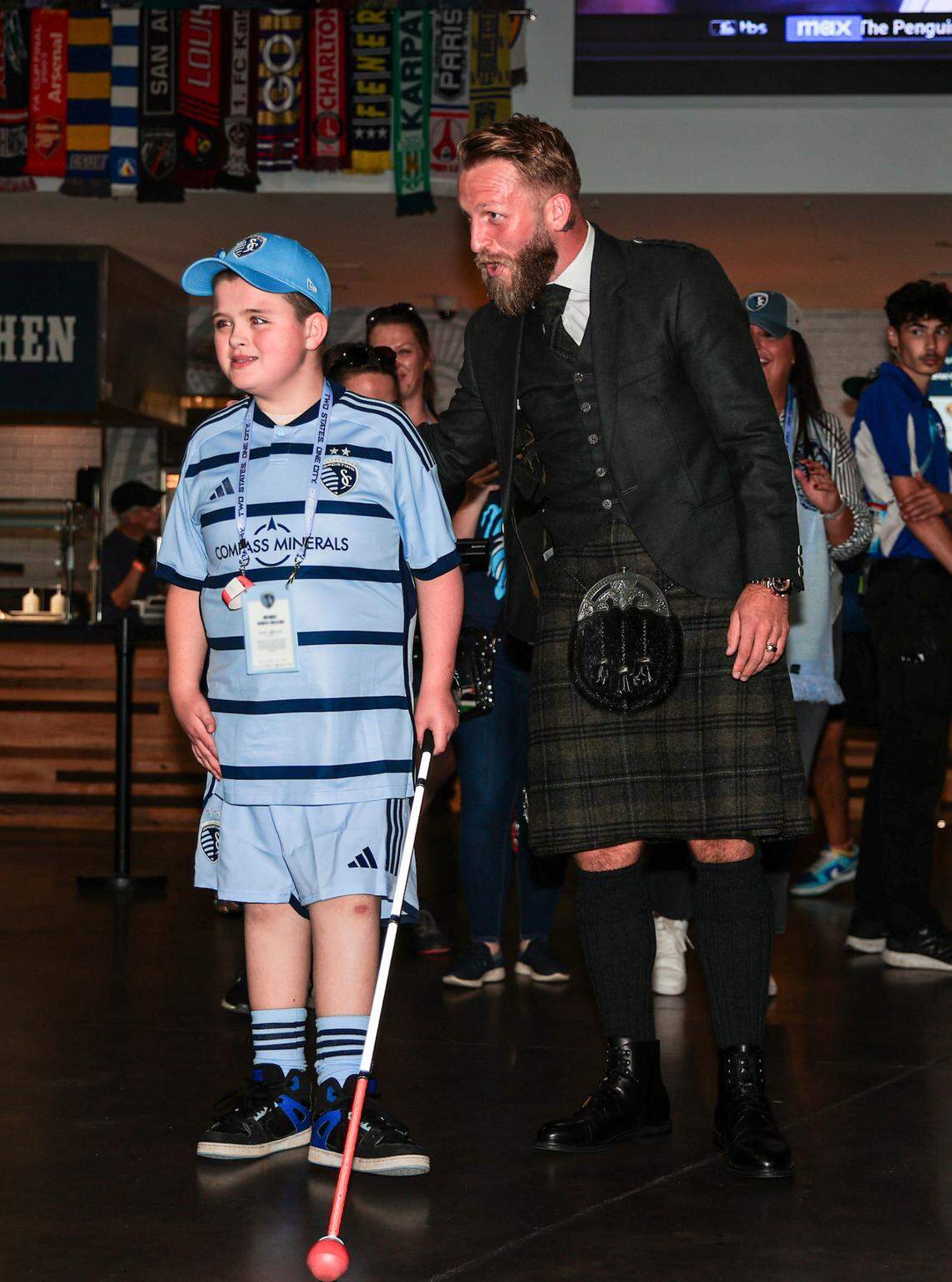 Eleven-year-old fan Miles Smith with Sporting KC’s Johnny Russell before a home match on Oct. 5, 2024.