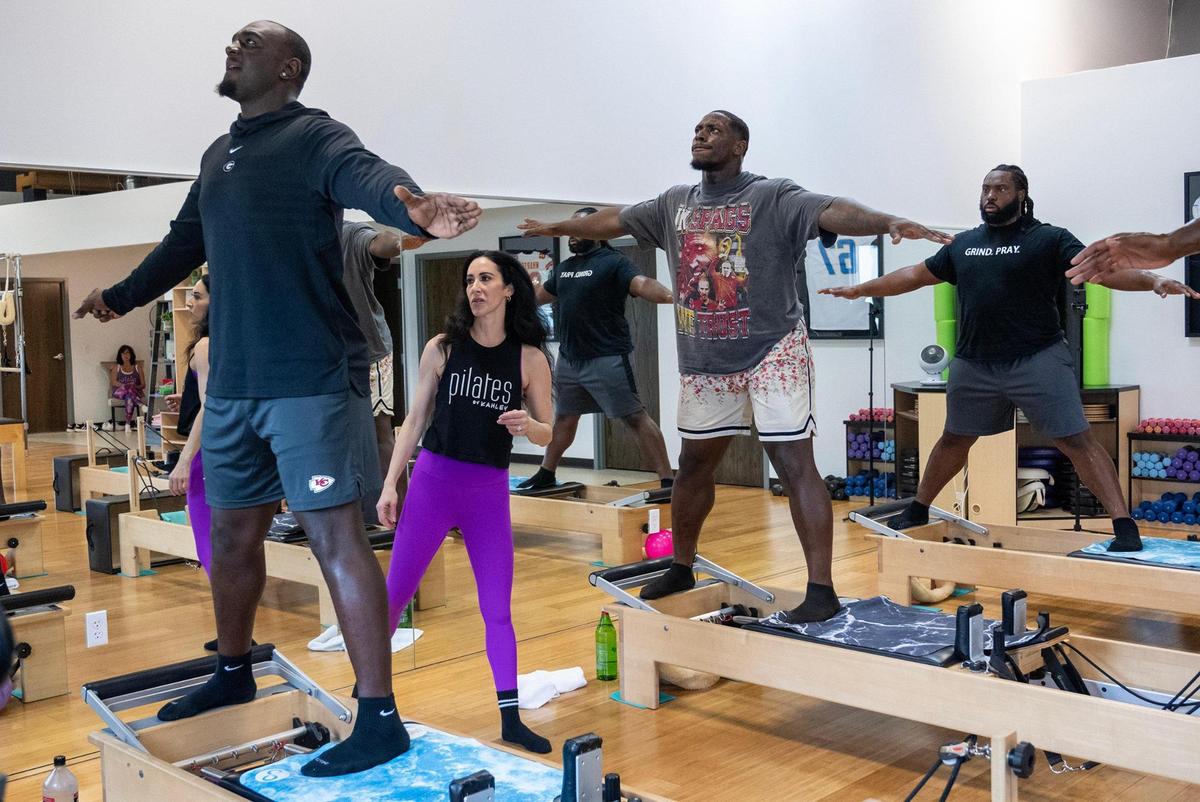 Certified pilates instructor Kahley Schiller guides Chiefs defensive end Malik Herring, from left, and defensive tackles Tershawn Wharton and Derrick Nnadi, as they work out on pilates reformer beds at Pilates By Kahley on Tuesday, Oct. 29, 2024, in Overland Park.